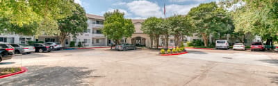 Exterior view of Solstice Senior Living at Austin with parking area