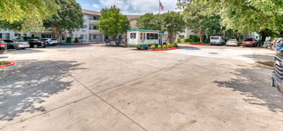 Exterior view of Solstice Senior Living with transportation van