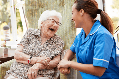 A happy interaction between a resident and staff member