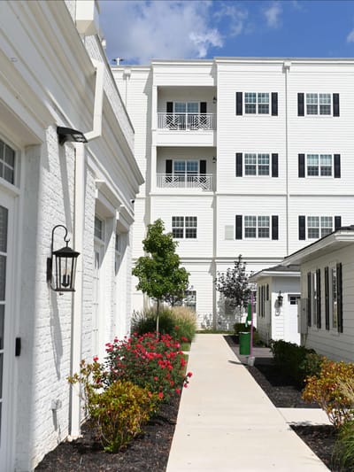 Pathway leading to the building with landscaped flowers