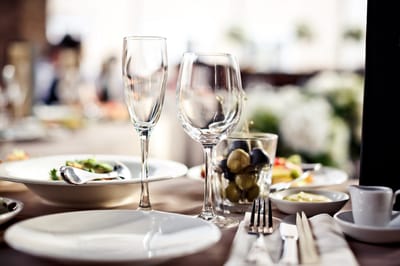 Elegant dining table set with glasses and meals