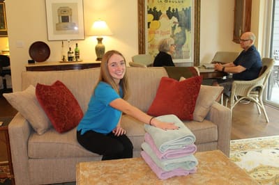 Staff member arranging towels in a common area