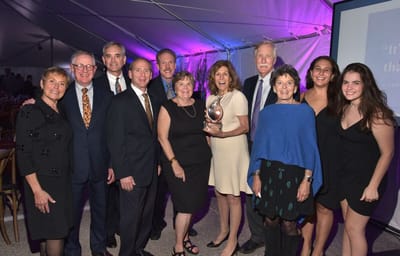 Residents and staff celebrating an award at a ceremony