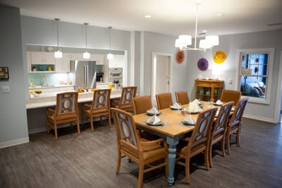 Dining area with large table and chairs in a modern setting