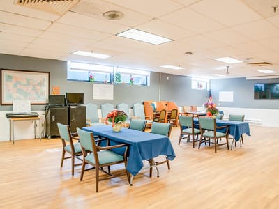 Bright common area with tables and chairs set up