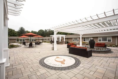 Outdoor patio area with seating and landscaping