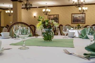 Set dining table with floral centerpiece in a dining room