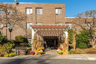 Exterior view of the facility entrance adorned with autumn decorations