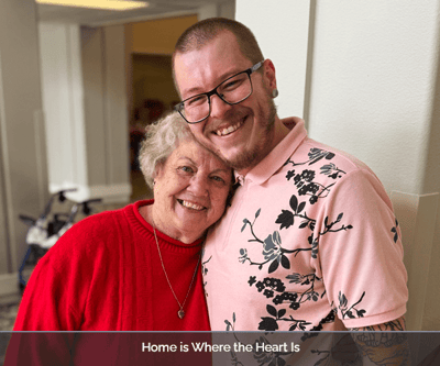 Resident and staff member sharing a joyful moment