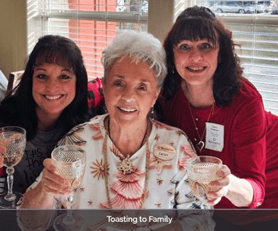 Residents celebrating with glasses raised in a common area
