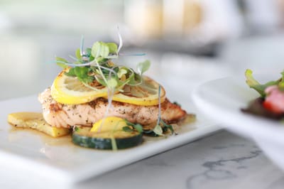 A beautifully plated meal with salmon and vegetables