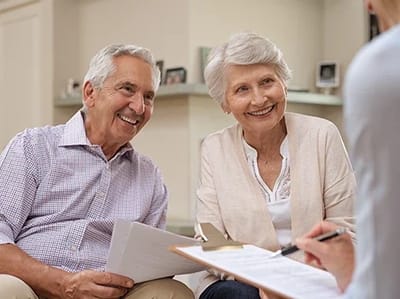 Couple smiling while reviewing documents together