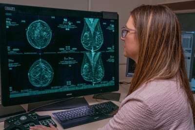 Medical professional analyzing mammogram images
