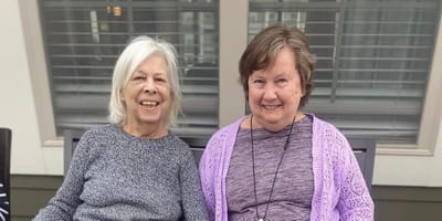 Two smiling residents enjoying time together