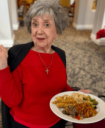 A resident enjoying a meal in the dining area