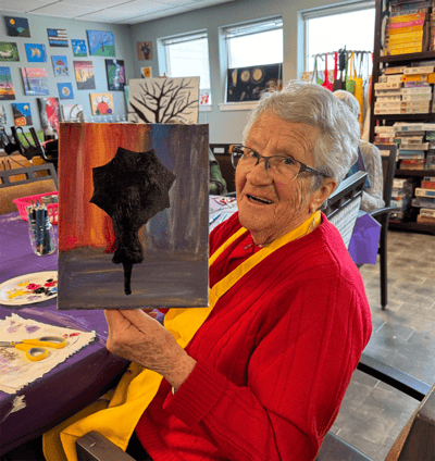 Resident painting in an activity room