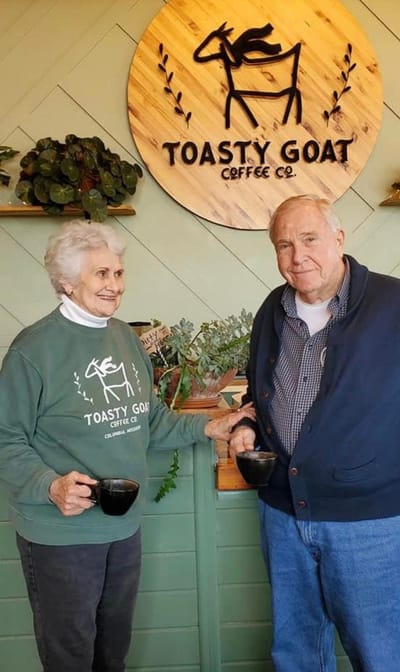 Two elderly residents enjoying coffee together in a cozy café