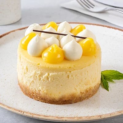 A slice of lemon cheesecake with decorative toppings