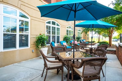 Outdoor seating area with umbrellas and greenery