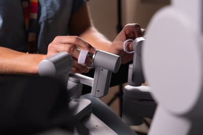 Close-up of hands adjusting medical equipment
