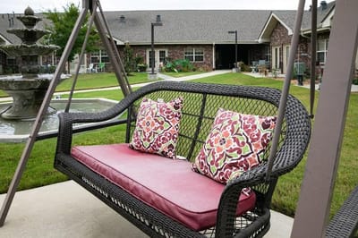 Outdoor seating area with a swing and fountain