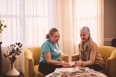 Staff member showing photo album to a resident