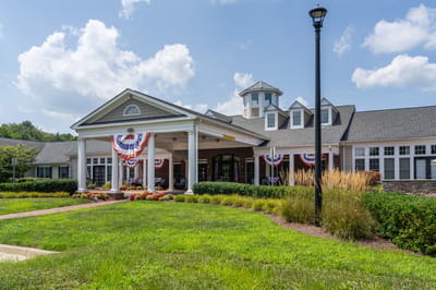 Exterior view of a senior living facility with patriotic decor
