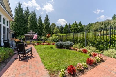 A peaceful outdoor garden area with seating and flowers