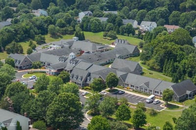 Aerial view of a senior living community with landscaped grounds