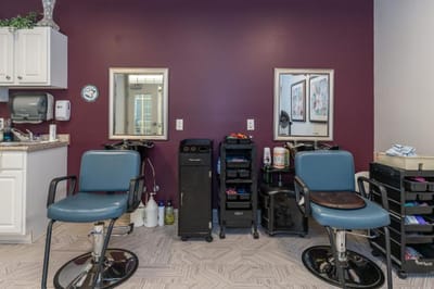 Hair salon area with chairs and mirrors