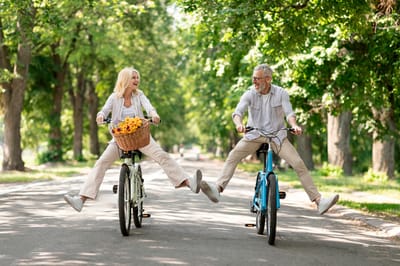 Active seniors biking together in a park