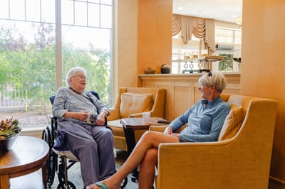 Residents chatting in a comfortable lounge area