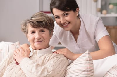 A staff member smiling with a senior resident
