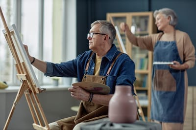Residents enjoying a painting activity in an art class