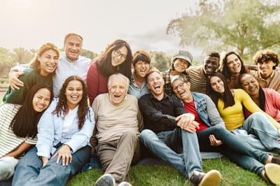 Group of smiling residents and staff outdoors