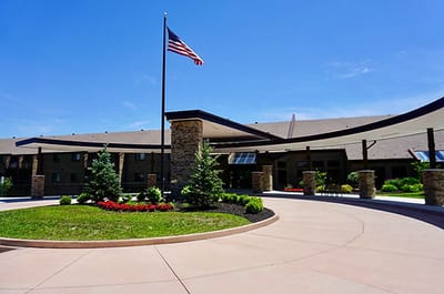Building exterior of Brookwood Retirement Community with landscaping