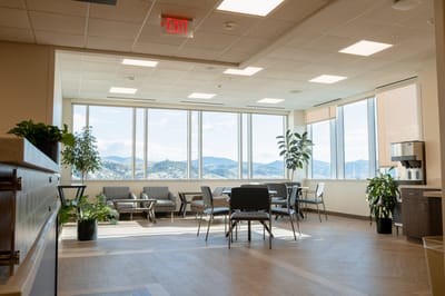 Bright common area with large windows and seating