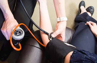 Healthcare professional taking a resident's blood pressure