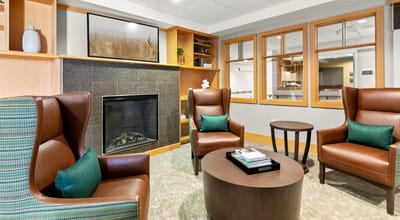 Cozy common area with armchairs and fireplace