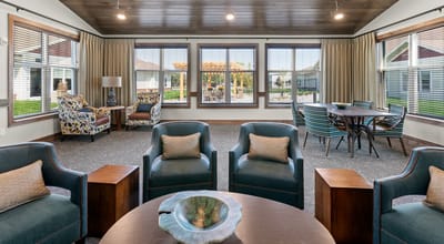 Interior of a common area with comfortable seating and large windows