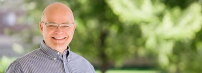 Smiling resident outdoors in a green space