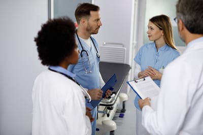 Medical staff discussing patient care in a treatment room
