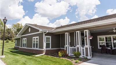 Exterior view of a senior living facility with landscaping