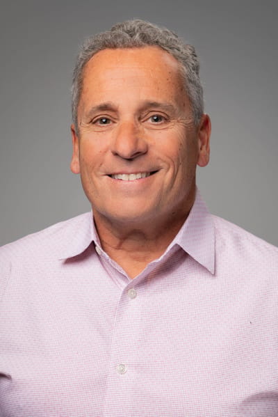 Portrait of a man smiling in a collared shirt