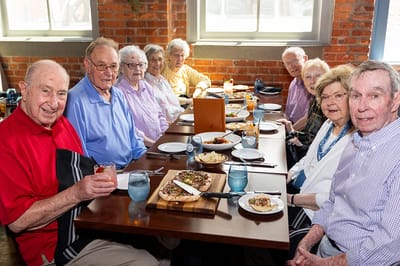 Residents enjoying a meal together at a dining table