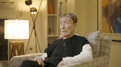 Senior resident sitting in a well-lit common area