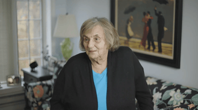 Resident smiling in a cozy interior setting