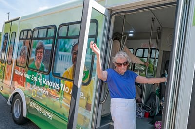 Resident exiting facility transport bus