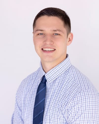 Young man in a professional attire smiling
