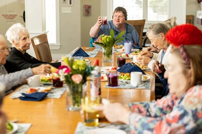 Residents enjoying a meal together in a dining room